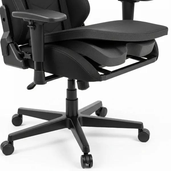 A close-up of a budget gaming chair showcasing its metal wheelbase, sturdy armrest connection, and high-density foam cushioning.